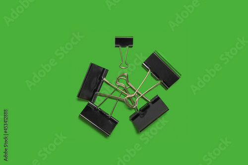 paper clips on a green surface. school and office