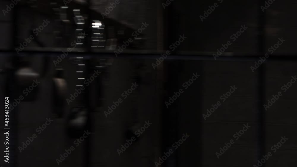 A shirtless man struggling in the prison and pulls on the bars of the cell A shirtless man struggling in the prison and pulls on the bars of the cell