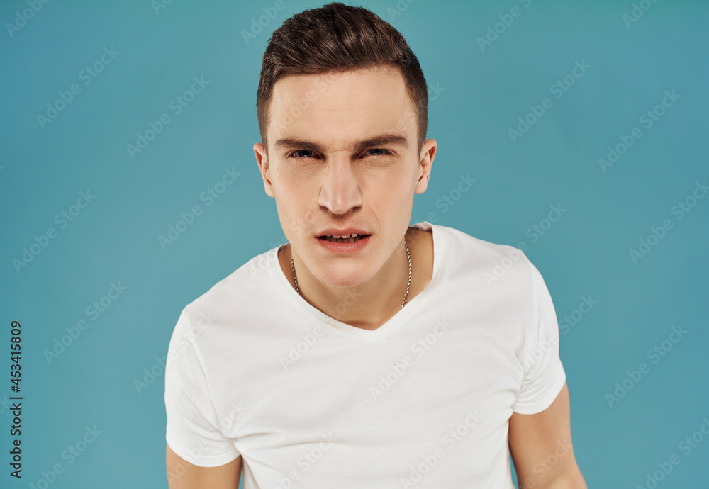 angry man with displeased facial expression in white t-shirt angry man with displeased facial expression in white t-shirt