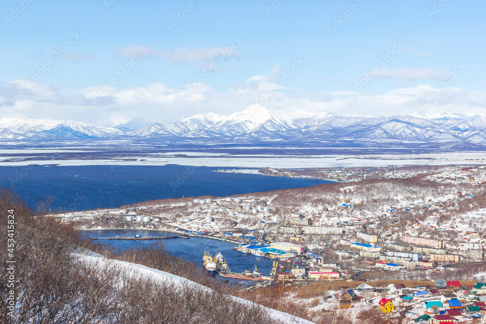 A settlement in the north, houses covered with snow and a seaport. Winter landscape with mountains. the concept of life beyond the arctic circle. A settlement in the north, houses covered with snow and a seaport. Winter landscape with mountains. the concept of life beyond the arctic circle.