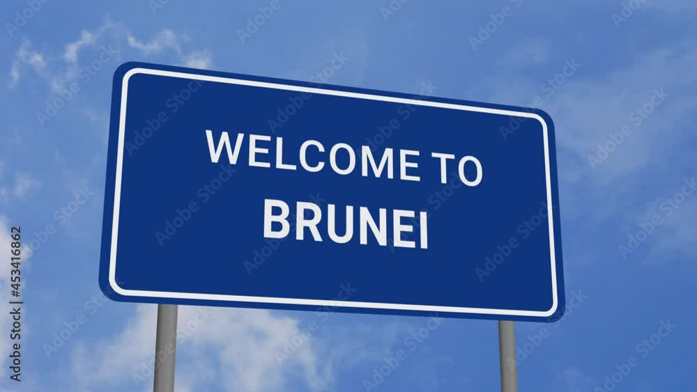 Welcome to Brunei Road Sign on Clear Blue Sky with Rapid Moving Clouds Welcome to Brunei Road Sign on Clear Blue Sky with Rapid Moving Clouds