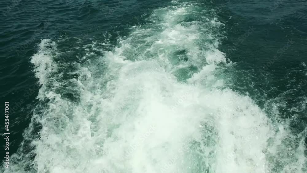 View from the deck of the yacht at the bow, close up. Side view with green sea and waves. Concept, lifestyle and freedom. Slow motion. View from the deck of the yacht at the bow, close up. Side view with green sea and waves. Concept, lifestyle and freedom. Slow motion.