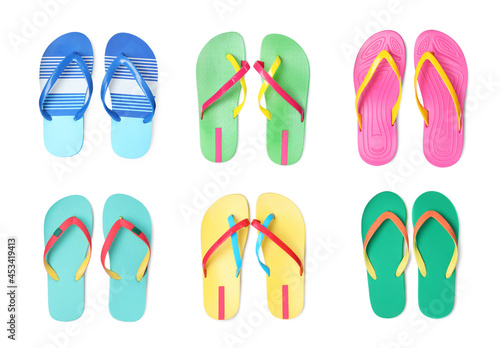Set with different flip flops on white background, top view