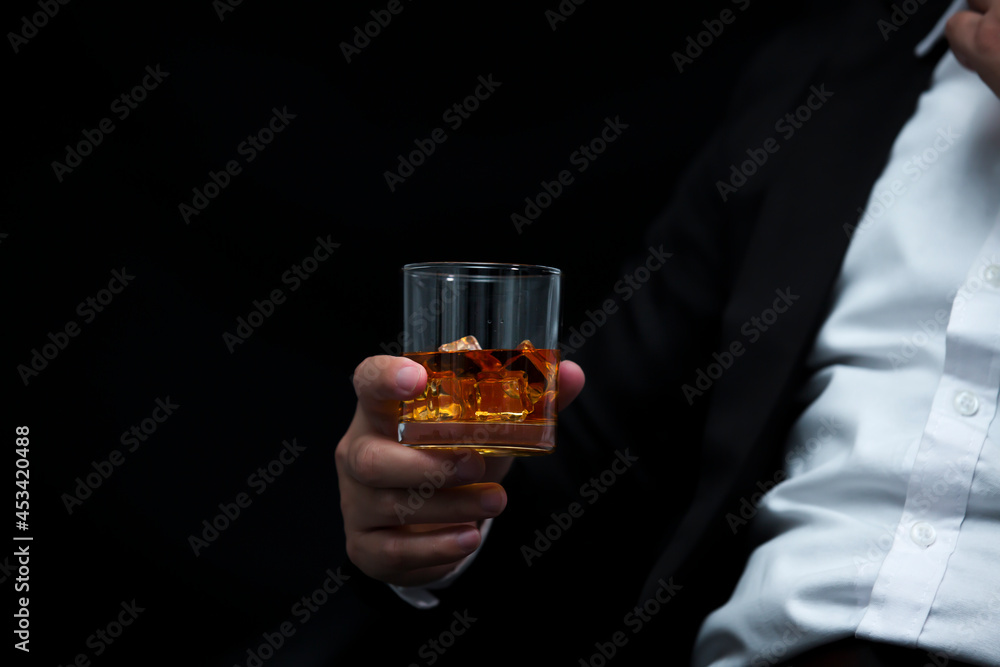 Closeup businessmen holding a glass of whiskey Closeup businessmen holding a glass of whiskey