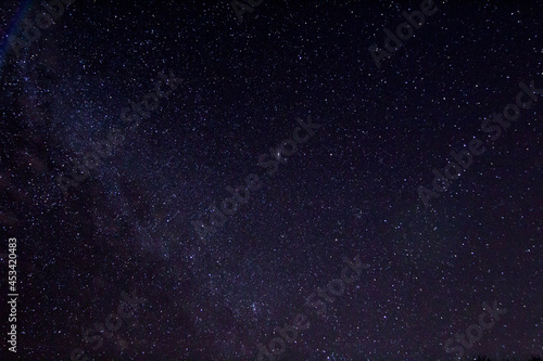 Night sky with andromeda as a blured bright spot in the center of the frame
