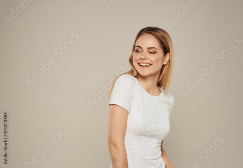 cheerful woman in a white t-shirt hand gesture Studio Model