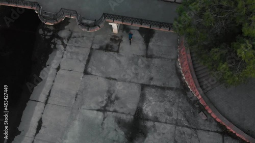 Aerial top view of bicyclist ride under bridge near river in Almaty, Kazakhstan photo