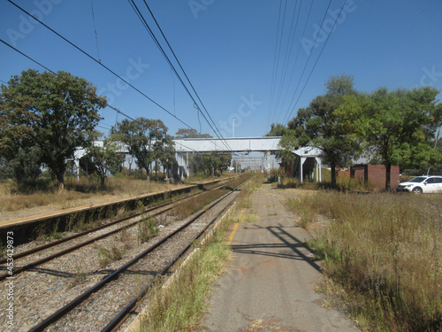 A disused Railway Siding, long forgotten and left derelict with encroaching grass and wild plants as well as weeds, and only the passing trains to keep it real with nobody to see it