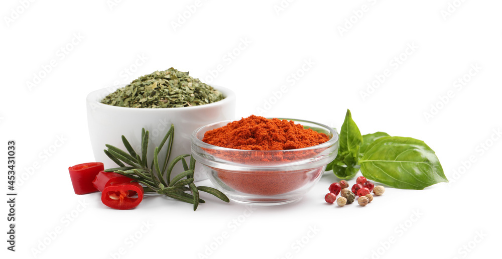 Different natural spices and herbs on white background Different natural spices and herbs on white background