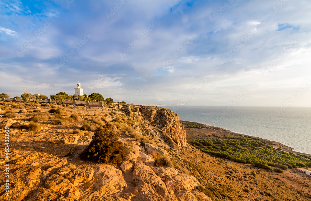 Obraz premium Santa Pola lighthouse. landscape of the Mediterranean coast in the city of Santa Pola. Coastal city located in the Valencian community, Alicante, Spain