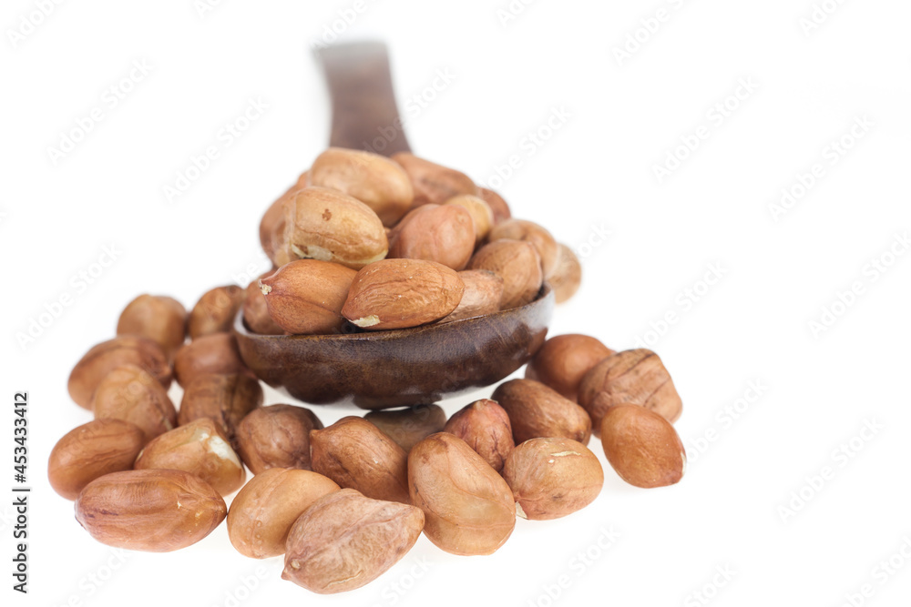 Obraz premium Peanut in wood spoon on white background.