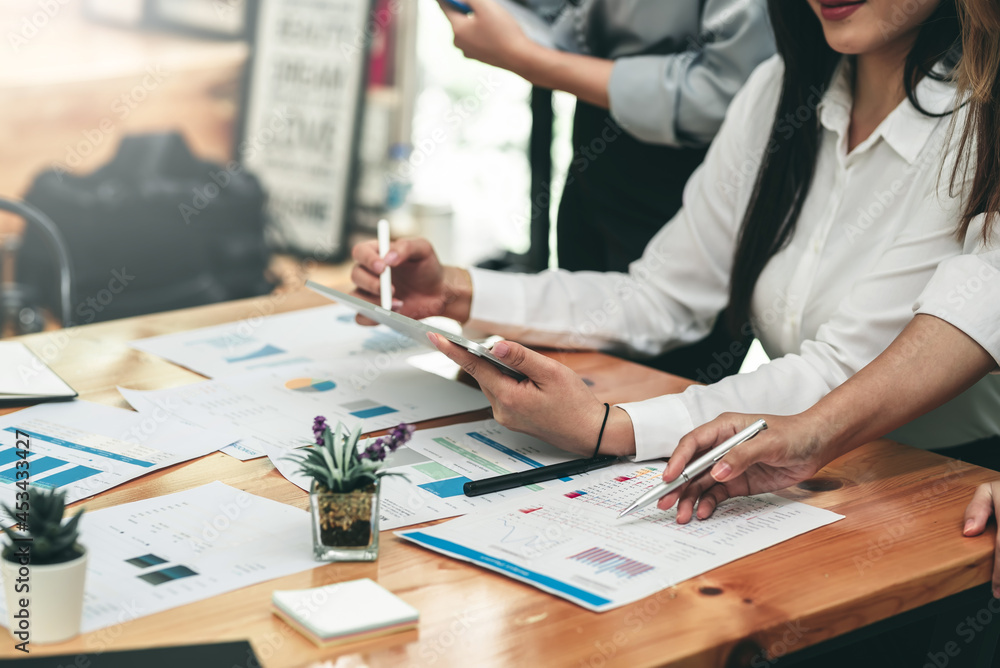 Image of a group of business people meeting a brainstorming together using tablet graph paper statistics at the office. Image of a group of business people meeting a brainstorming together using tablet graph paper statistics at the office.