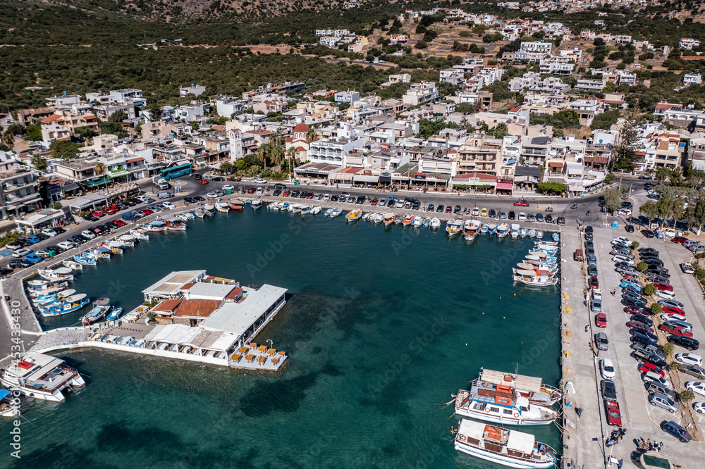 panoramic view of the sea and mountains and ships on turquoise water filmed from a drone