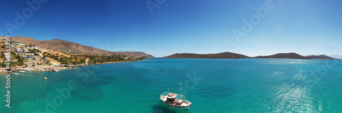 panoramic view of the sea and mountains and ships on turquoise water filmed from a drone © константин константи