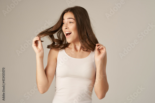 beautiful woman in a white t-shirt hair care isolated background