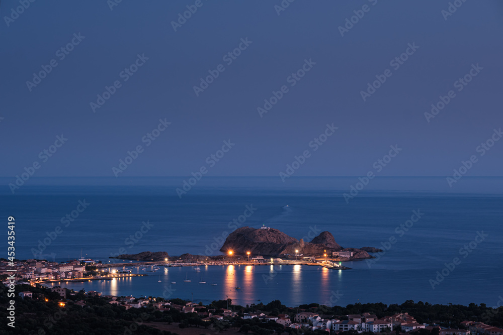 Night falling over La Pietra at in the Mediterranean sea at Ile Rousse in the Balagne region of Corsica
