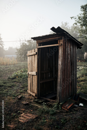 Old rural toilet early at dawn in fog