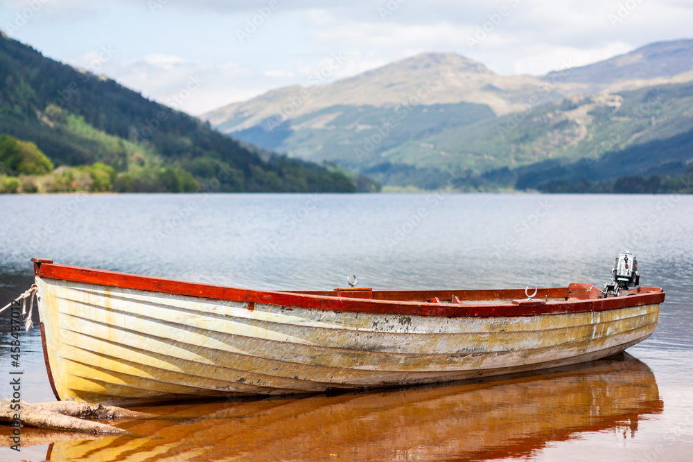 Clinker boat or skiff on a lake in summer, Scotland, UK Clinker boat or skiff on a lake in summer, Scotland, UK