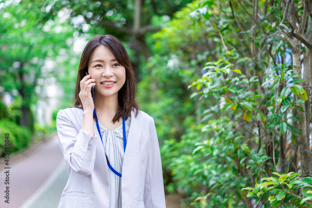 外で電話をするビジネスウーマン