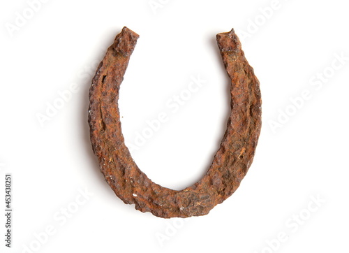 very old ancient rusty horse horseshoe isolated on white background