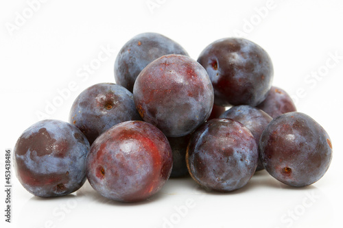 Ripe blue plums isolated on white background