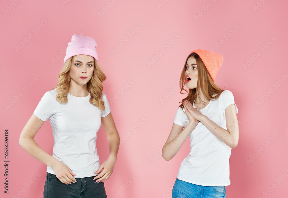 two women stand side by side youth style fun friendship pink background two women stand side by side youth style fun friendship pink background