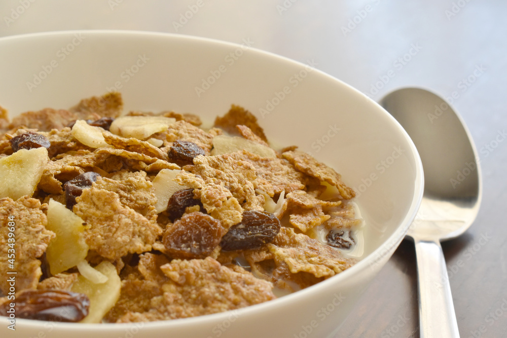 Fruit and fiber cereal with milk closeup in a bowl. The concept of healthy breakfast, healthy food, dietary plan and weight loss program. Fruit and fiber cereal with milk closeup in a bowl. The concept of healthy breakfast, healthy food, dietary plan and weight loss program.