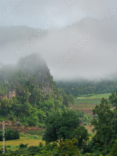 Beautiful misty morning rural landscape in mountain valley near Chiang Dao, Chiang Mai, Thailand