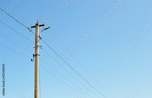 Power electric pole with line wire on colored background close up photo