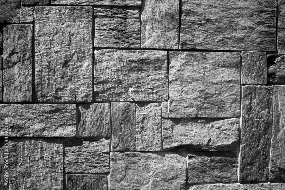 evocative black and white image of granite wall with joints between tiles evocative black and white image of granite wall with joints between tiles