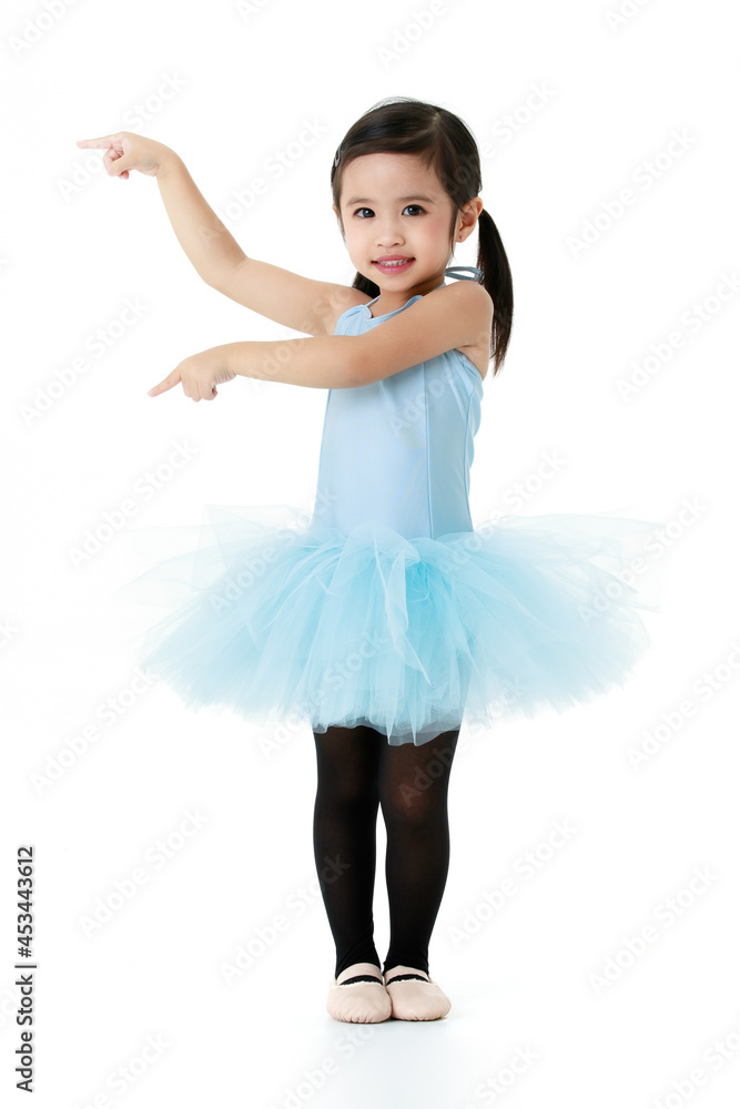 Portrait isolated studio shot of little cute Asian preschool pigtails hairstyle ballerina dancer girl in blue tutu ballet dress black legging stand smiling posing pointing fingers on white background Portrait isolated studio shot of little cute Asian preschool pigtails hairstyle ballerina dancer girl in blue tutu ballet dress black legging stand smiling posing pointing fingers on white background