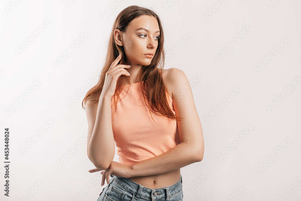 Beautiful young girl smiling and posing looking at the camera on a white isolated background. Positive brunette woman. Kind look. Beauty face Beautiful young girl smiling and posing looking at the camera on a white isolated background. Positive brunette woman. Kind look. Beauty face