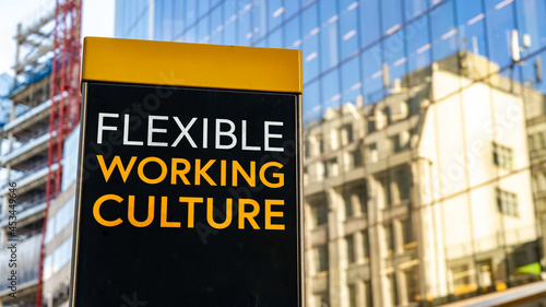 Flexible Working Culture on a city-center sign in front of a modern office building