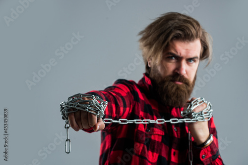 Obraz na plátne Brutal bearded man pull steel chain, Break the vicious circle