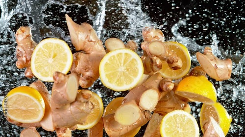 Super Slow Motion Shot of Flying Ginger Cuts, Lomen Slices and Water Side Splash at 1000 fps. photo