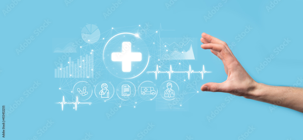 Businessman hold virtual plus medical network connection icons. Covid-19 pandemic develop people awareness and spread attention on their healthcare.Doctor,document,medicine,ambulance,patient icon. Businessman hold virtual plus medical network connection icons. Covid-19 pandemic develop people awareness and spread attention on their healthcare.Doctor,document,medicine,ambulance,patient icon.