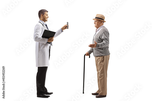 Male doctor showing a mobile phone to an elderly patient