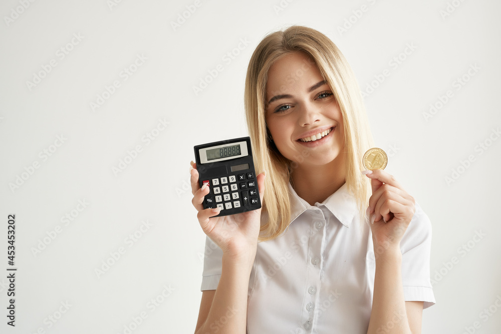 woman in white shirt calculator gold coin cryptocurrency woman in white shirt calculator gold coin cryptocurrency