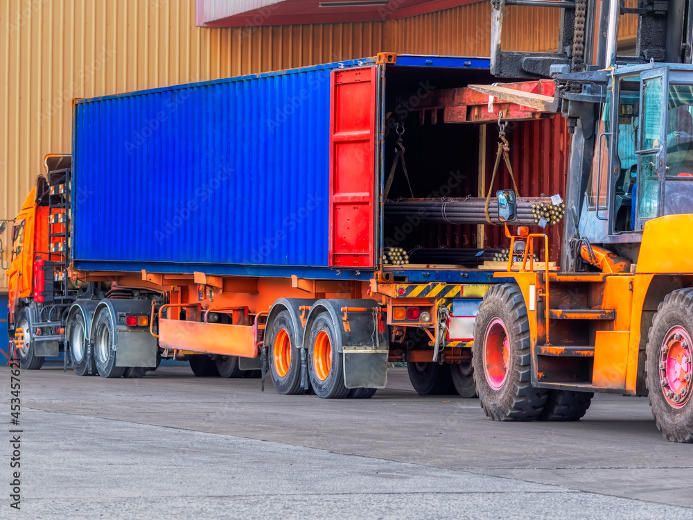 Unstuffing of steel round bar-iron metal rail lines material from container to store in warehouse. Unstuffing of steel round bar-iron metal rail lines material from container to store in warehouse.