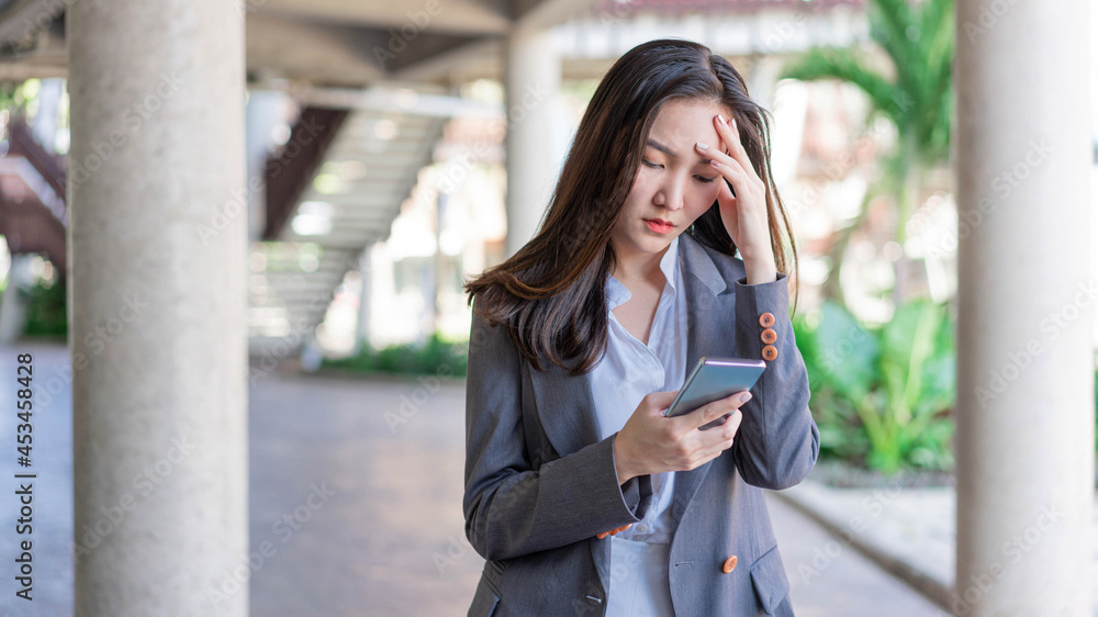 Fototapeta premium Working woman concept a young businesswoman fatigued after doing a load of work and spending too much time on electronic devices