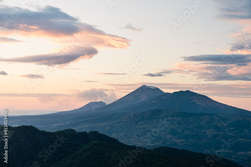 Aerial landscape view of volcanoes and clouds at sunset