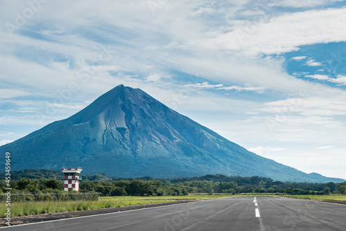Airport runway in nature next to volcano