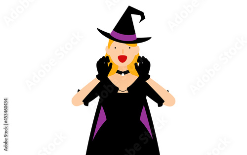 ハロウィンの仮装、魔女姿の女性が両手を構えて驚かせるポーズ