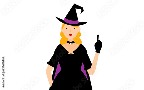 ハロウィンの仮装、魔女姿の女性が指さしをするポーズ