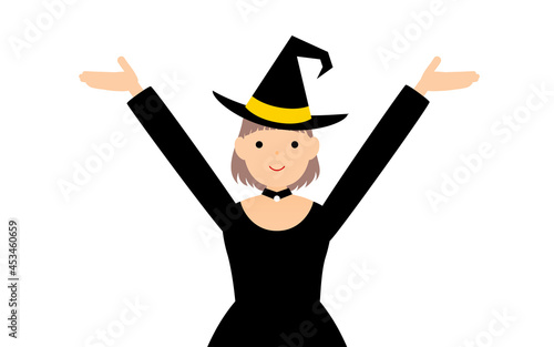 ハロウィンの仮装、魔女姿の女の子が両腕を上げるポーズ