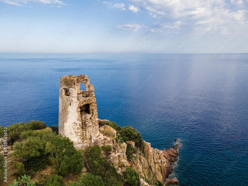 San Gemiliano fortress tower on the rocky coast on the blue sea. Sardinia, Italy. City of Arbatax.
