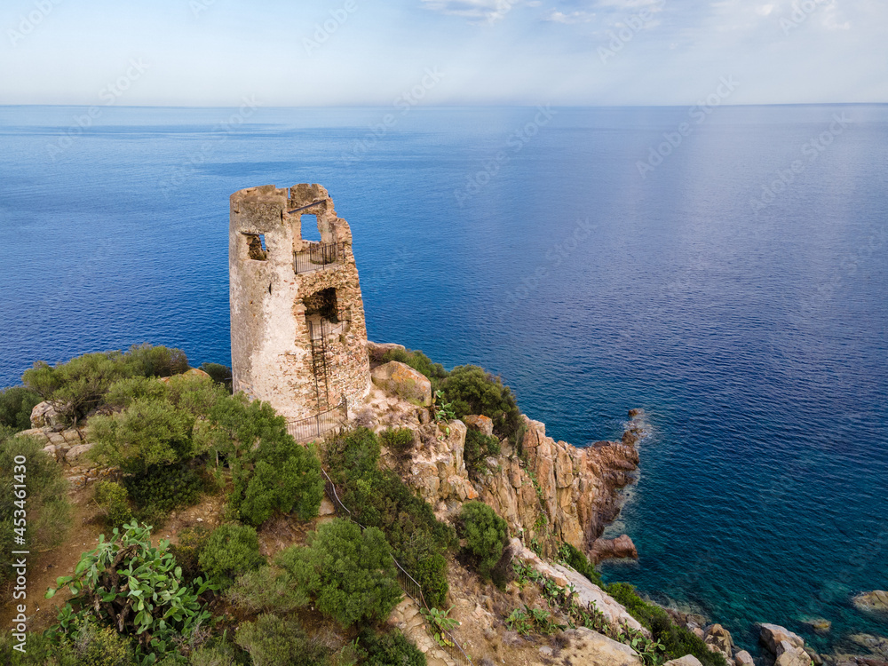 San Gemiliano fortress tower on the rocky coast on the blue sea. Sardinia, Italy. City of Arbatax.