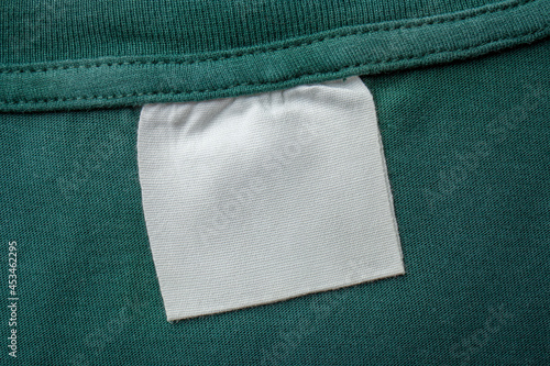 Cotton laundry care clothing label on fabric texture with place for text on fabric texture. Clothes with empty label or tag