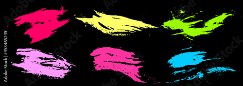Set of colorful brush strokes. Dirty grunge texture. Different grunge brush strokes. Dirty artistic design elements isolated on black background. Neon colorful ink. Vector illustration