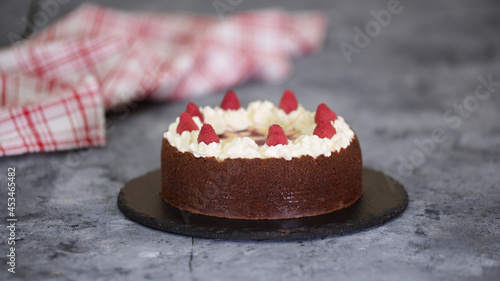 Sweet dessert, delicious chocolate raspberry cheesecake, decorated with fresh raspberries.
